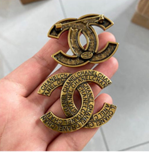 Golden word brooch
